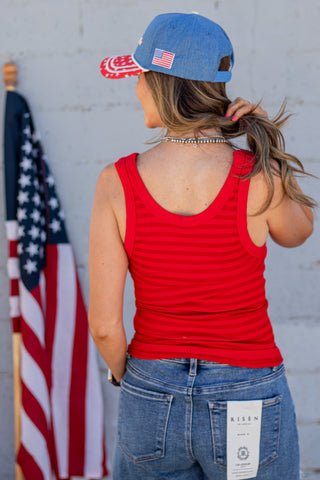 Person wearing a denim cap with 'America' and an American flag design.