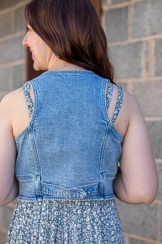 Denim vest over a floral dress with buttons