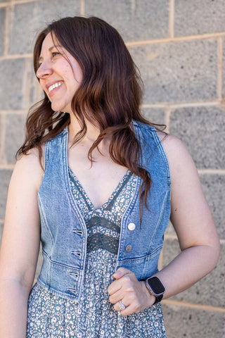 Denim vest over a floral dress with buttons