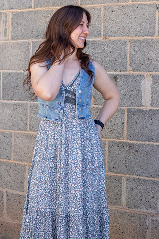 Denim vest over a floral dress with buttons
