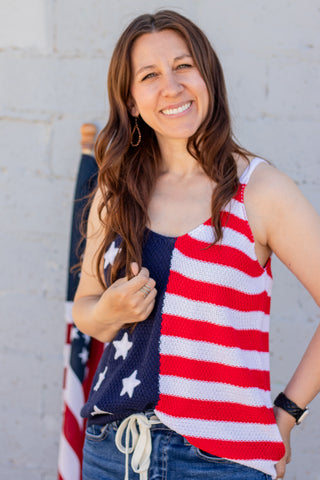 Woman wearing a sleeveless American flag top with a blurred background